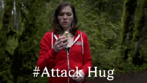 An animated gif of someone violently and suddenly hugging an oblivious person