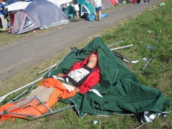 a man asleep in a collapsed tent