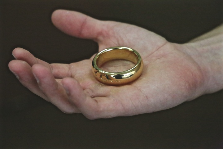 A gold ring with Elvish script on it